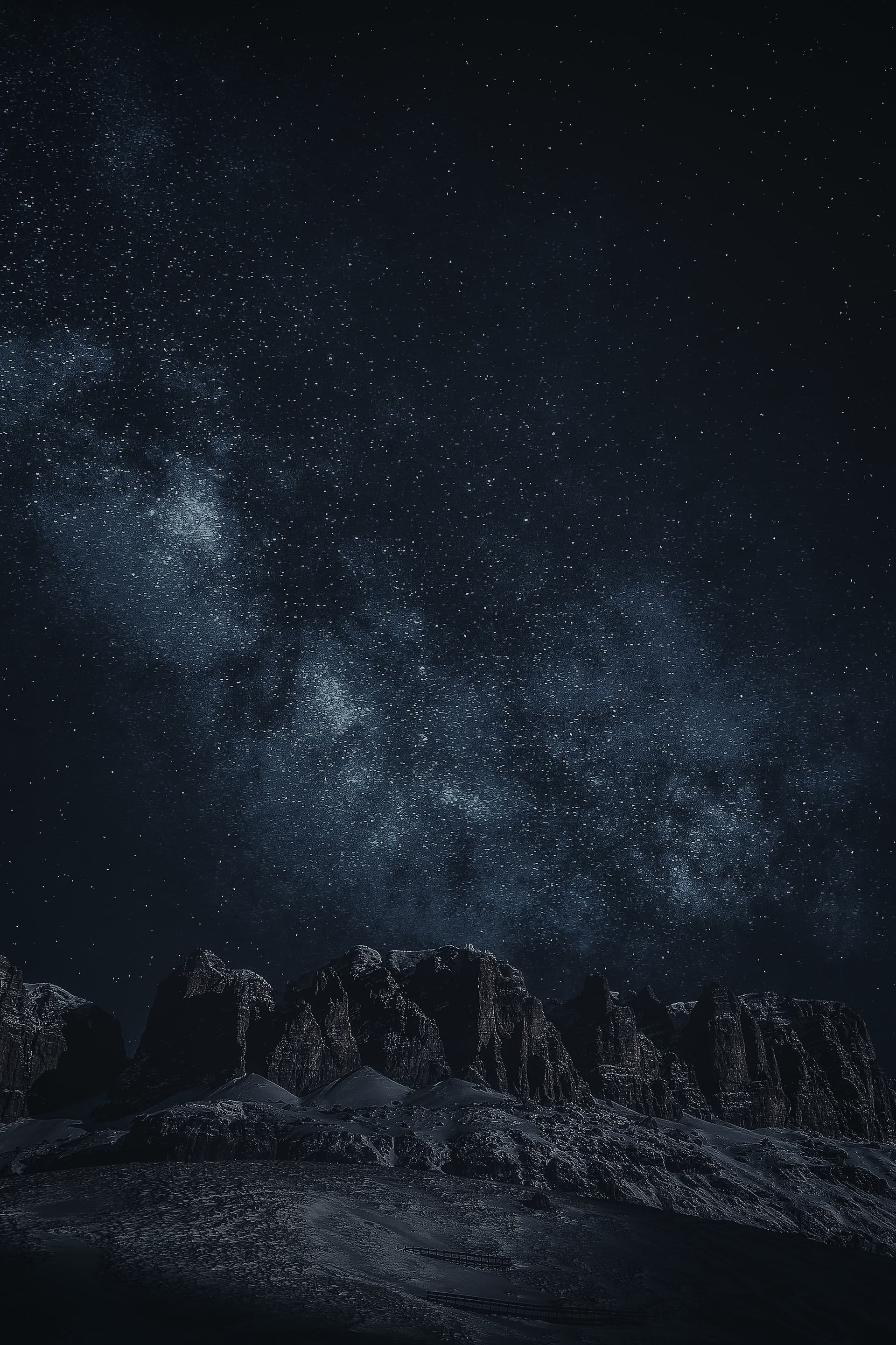 Night time shot of mountains with stars above.